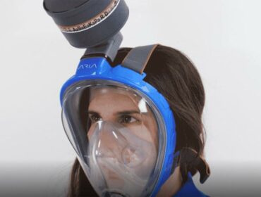 woman wears a modified full-face snorkeling mask from Ocean Reef