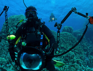 a diver with underwater photography lights