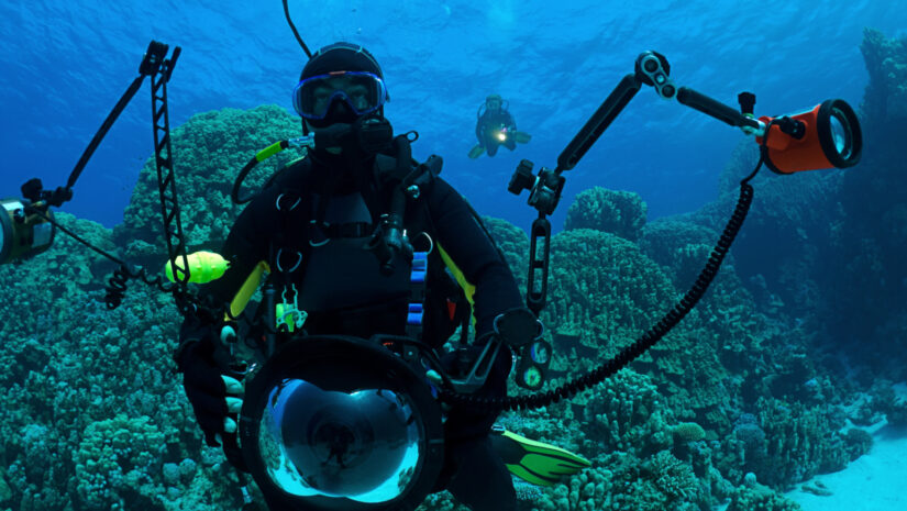 a diver with underwater photography lights