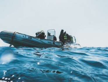 group of scuba divers on a boat about to go underwater