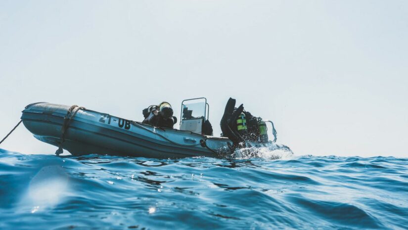 group of scuba divers on a boat about to go underwater