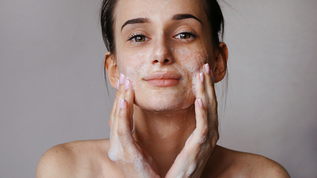 Woman cleansing her face