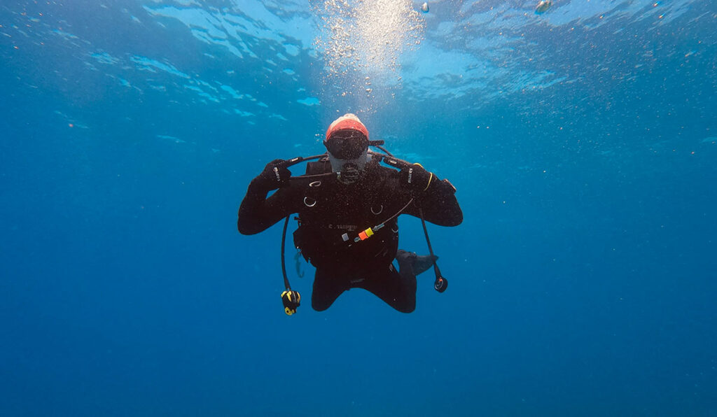 scuba diver underwater wearing scuba gloves