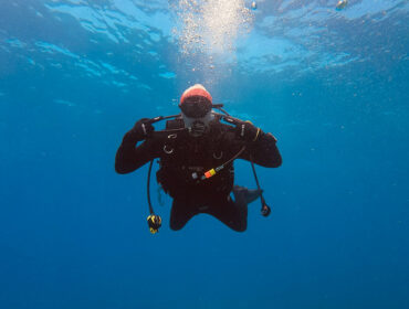 scuba diver underwater wearing scuba gloves