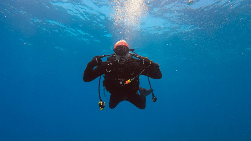 scuba diver underwater wearing scuba gloves