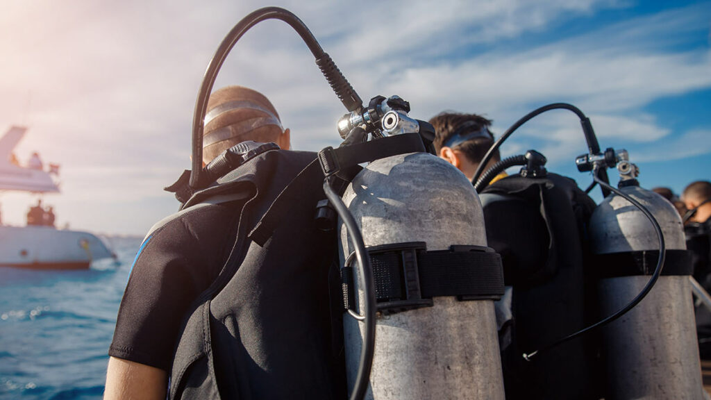 scuba divers sitting on boat during surface interval