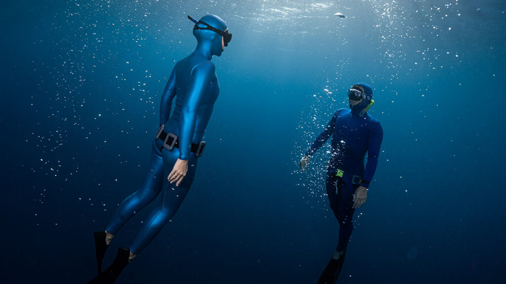 two freedivers underwater
