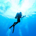 scuba diver ascending underwater