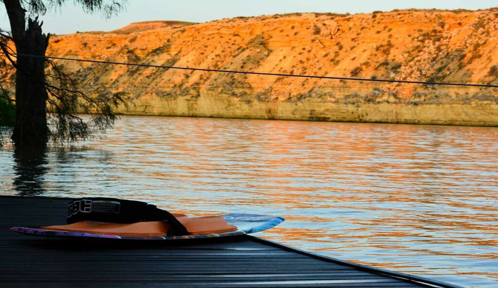 kneeboard on pier on lake