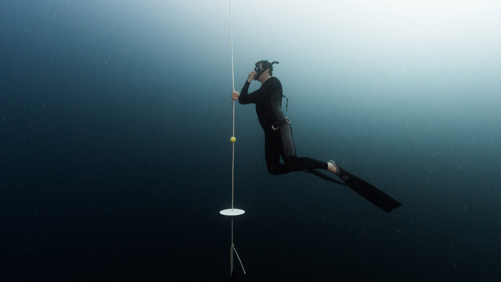 freediver equalizing ears underwater