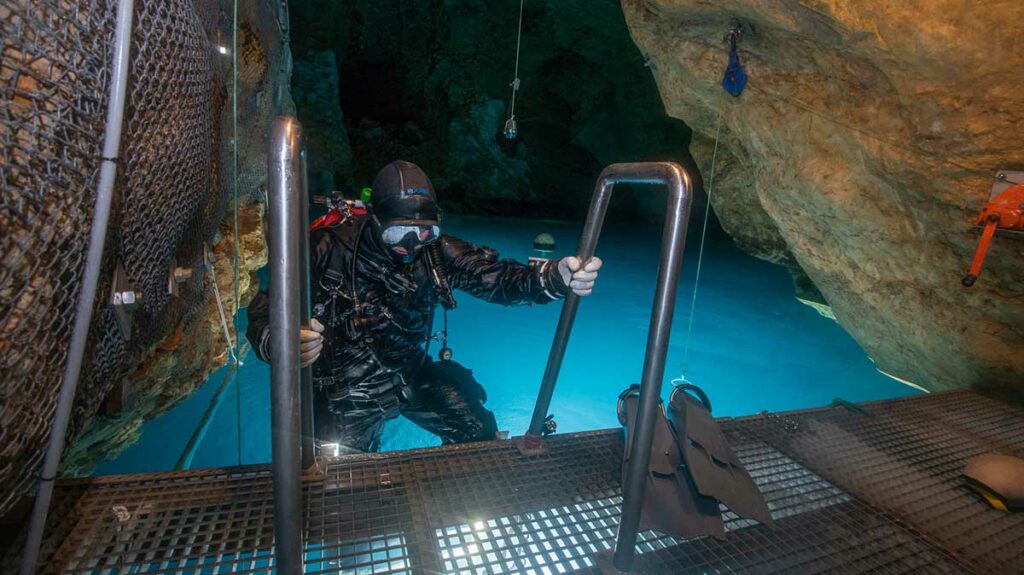 diver wearing drysuit leaving the water