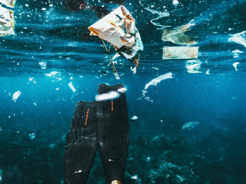Diver swimming in trash