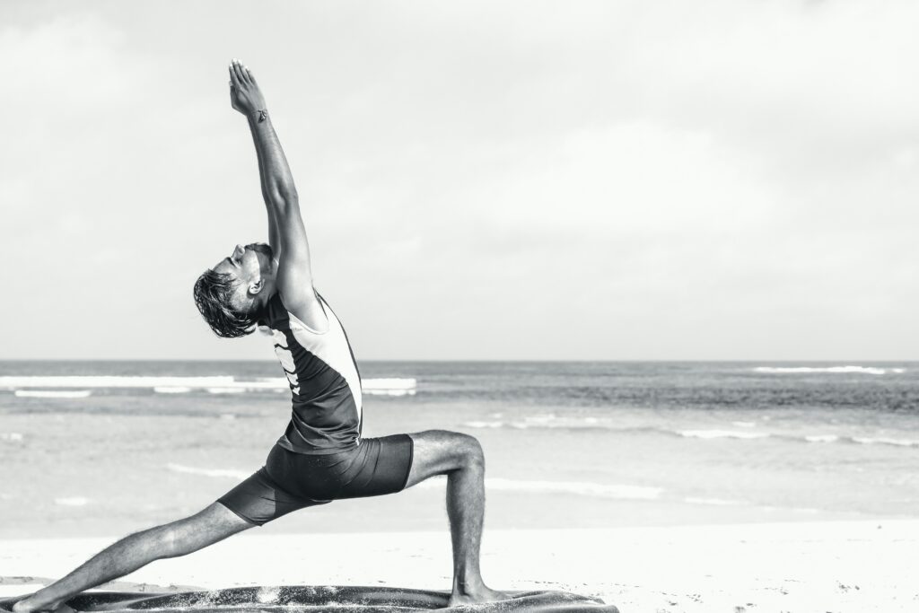 a man hitting a yoga pose on a paddleboard