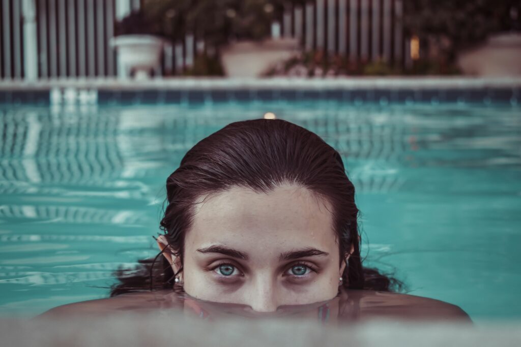 woman diver's eyes above the surface