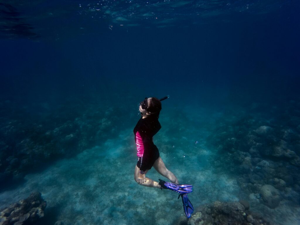 a woman diver who knows why the ocean is blue