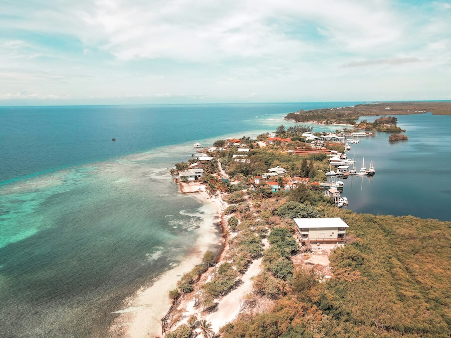 an aerial view of a small island in the middle of the ocean Panoramic view of Utila