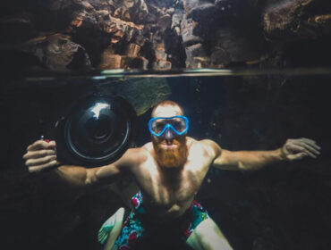 a man researching cave diving risks with his camera