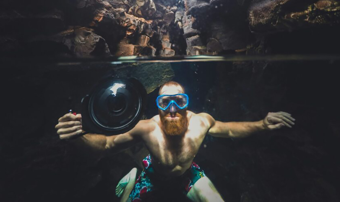 a man researching cave diving risks with his camera