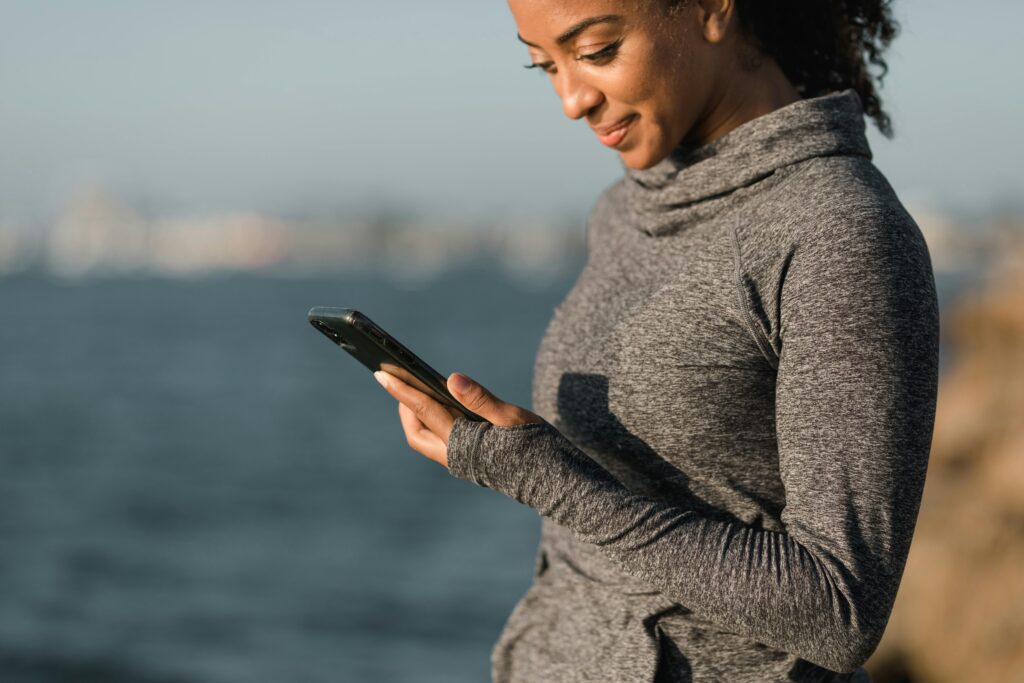 a diver above land checking her scuba diving app