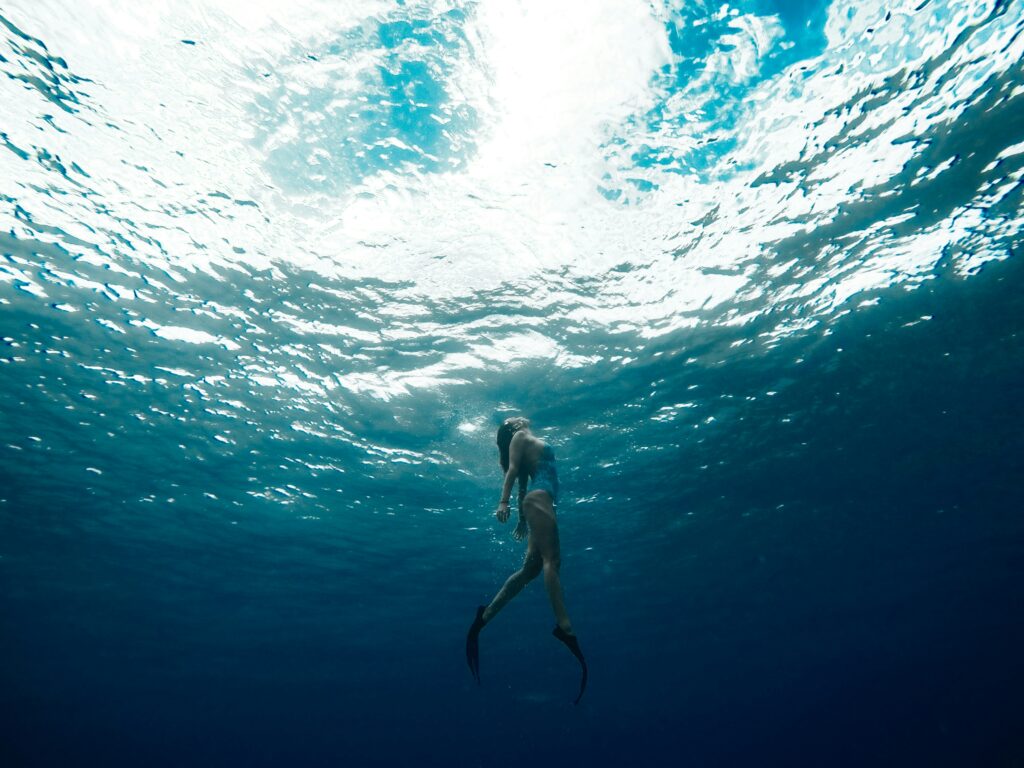 a female freediver going to the surface