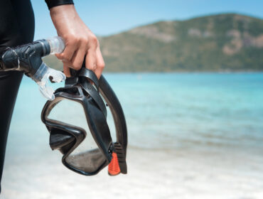 Snorkel and mask held in hand