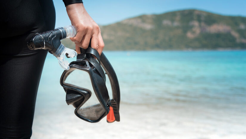 Snorkel and mask held in hand