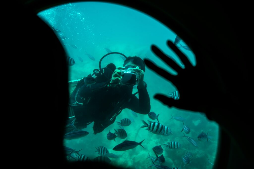 a diver waving to a diver who is taking a picture