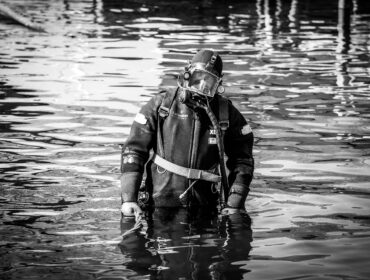 a diver poses for a black and white photo