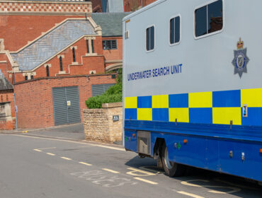 Underwater search unit mobile police scuba diving team parked at roadside whilst searching for a body in a river