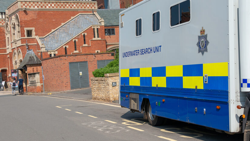 Underwater search unit mobile police scuba diving team parked at roadside whilst searching for a body in a river