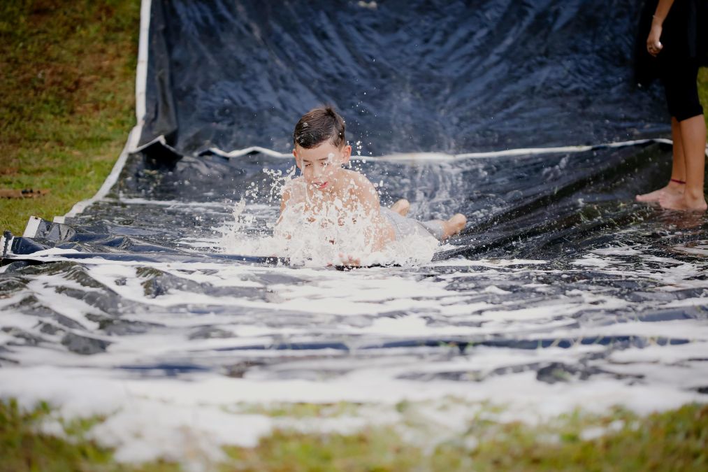 a diy slip n slide as a fun water activity in the backyard