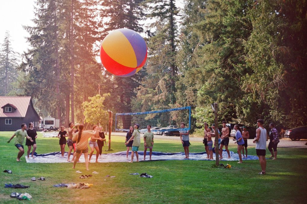 kids playing balloon volleyball near the beach