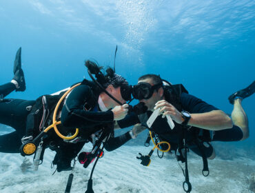 Man proposing marriage underwater to his fiancee