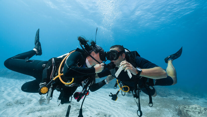 Man proposing marriage underwater to his fiancee