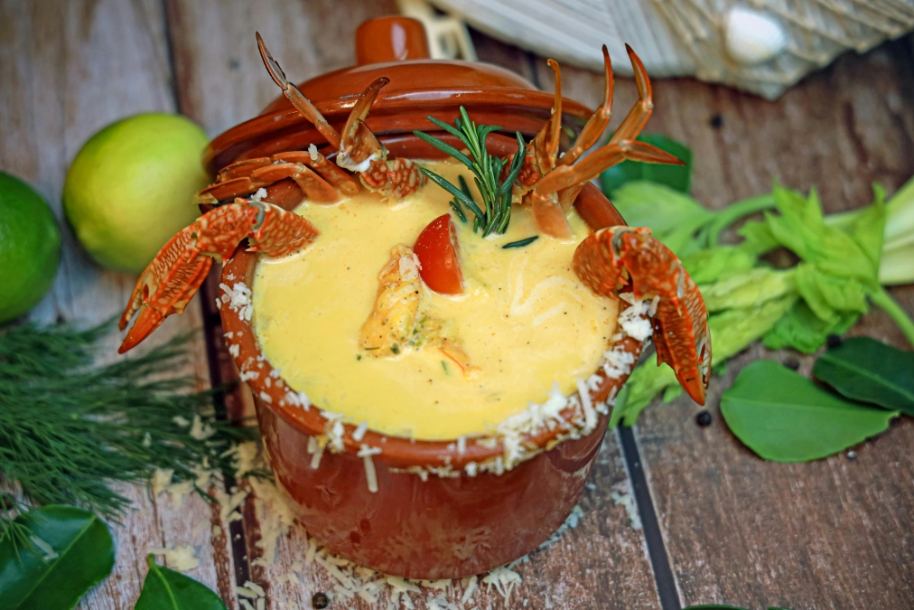 bowl of soup with lobster and vegetables