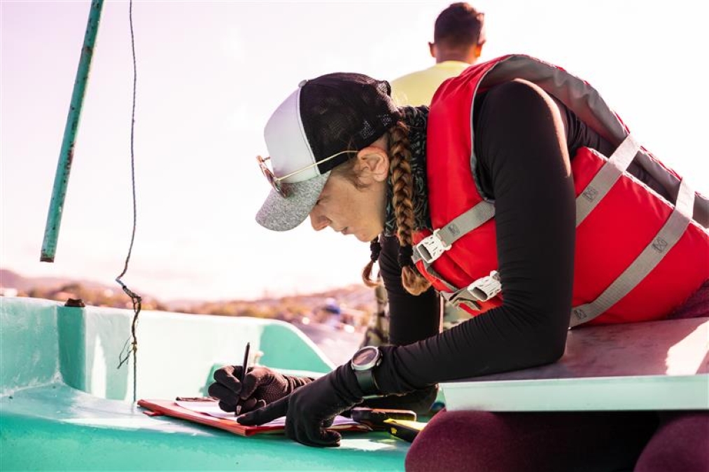 girl wearing life vest and a cap
