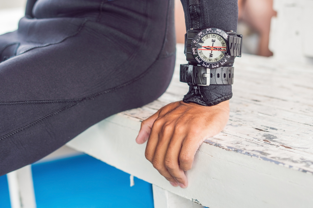 Young diver preparing an underwater compass for diving.
