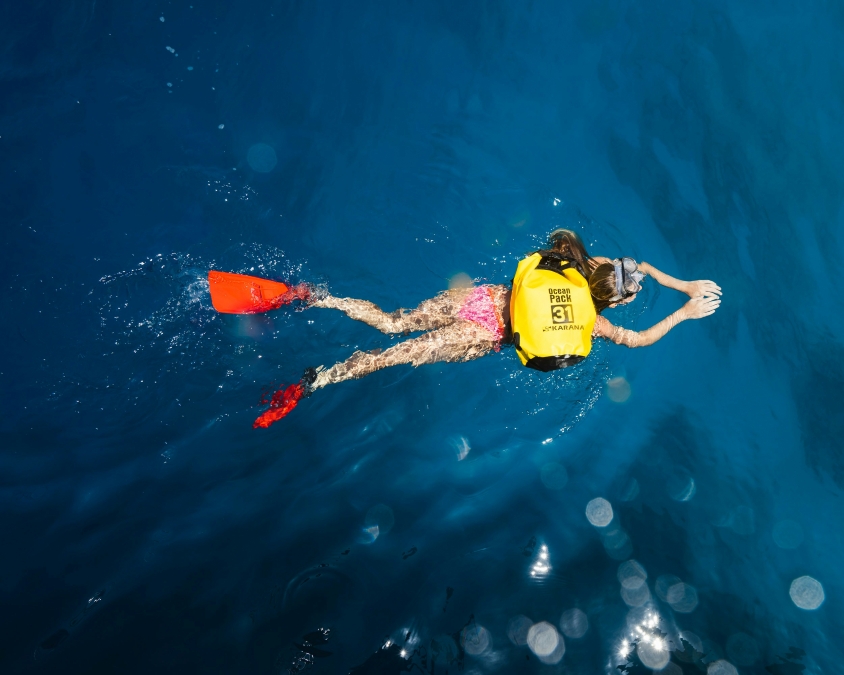 snorkeler uses a waterproof dive bag