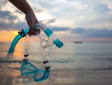man holding snorkel set