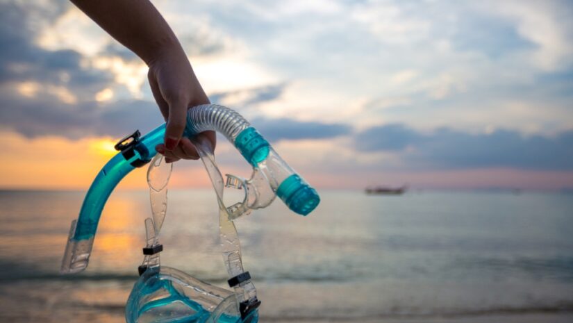 man holding snorkel set