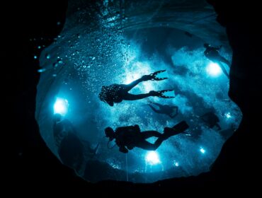 a group night diving holding their flashlights