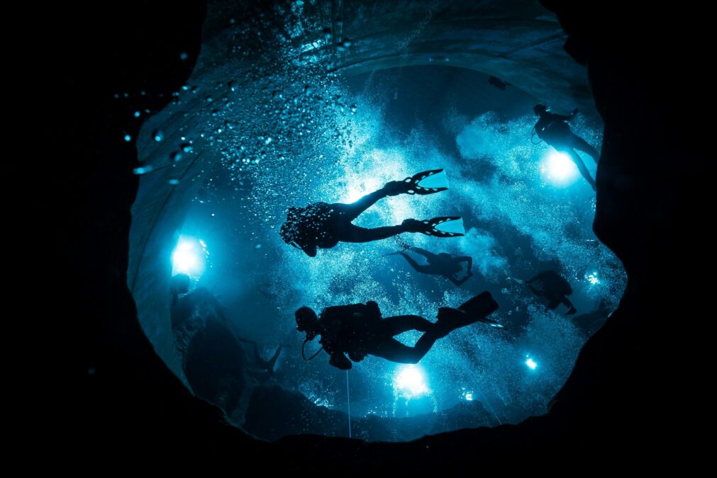 a group night diving holding their flashlights