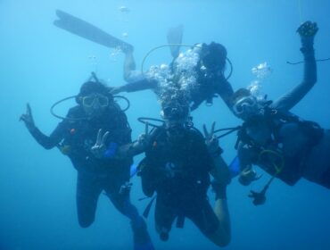 scuba diving friends posing happily for the camera