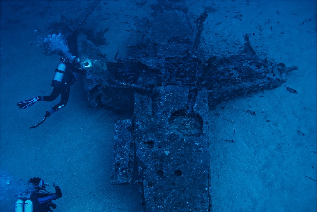 wreck site at night with divers around it