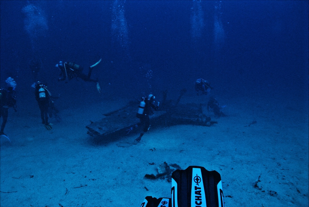 divers surrounding a wreck site
