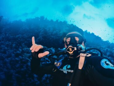 scuba diver posing for a picture with complete scuba equipment
