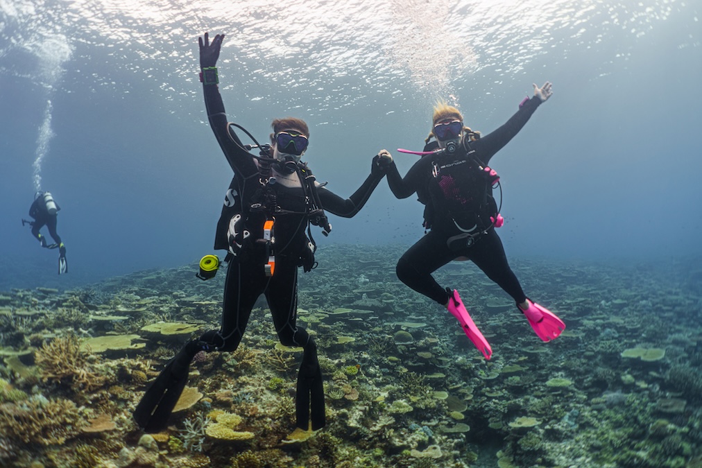 two divers posing for the camera