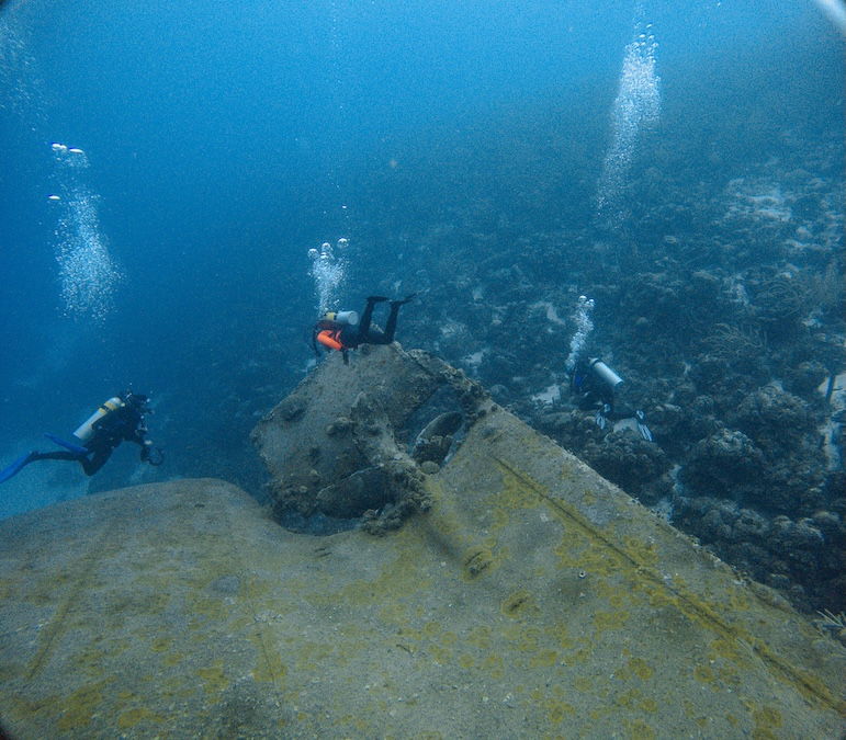 a team of divers assessing a wreck