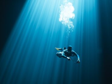 lone diver swimming in open ocean