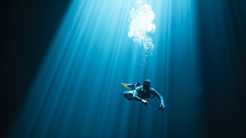 lone diver swimming in open ocean